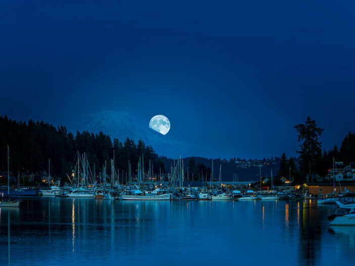 A full moon lights up the boats in Gig Harbor, washington.