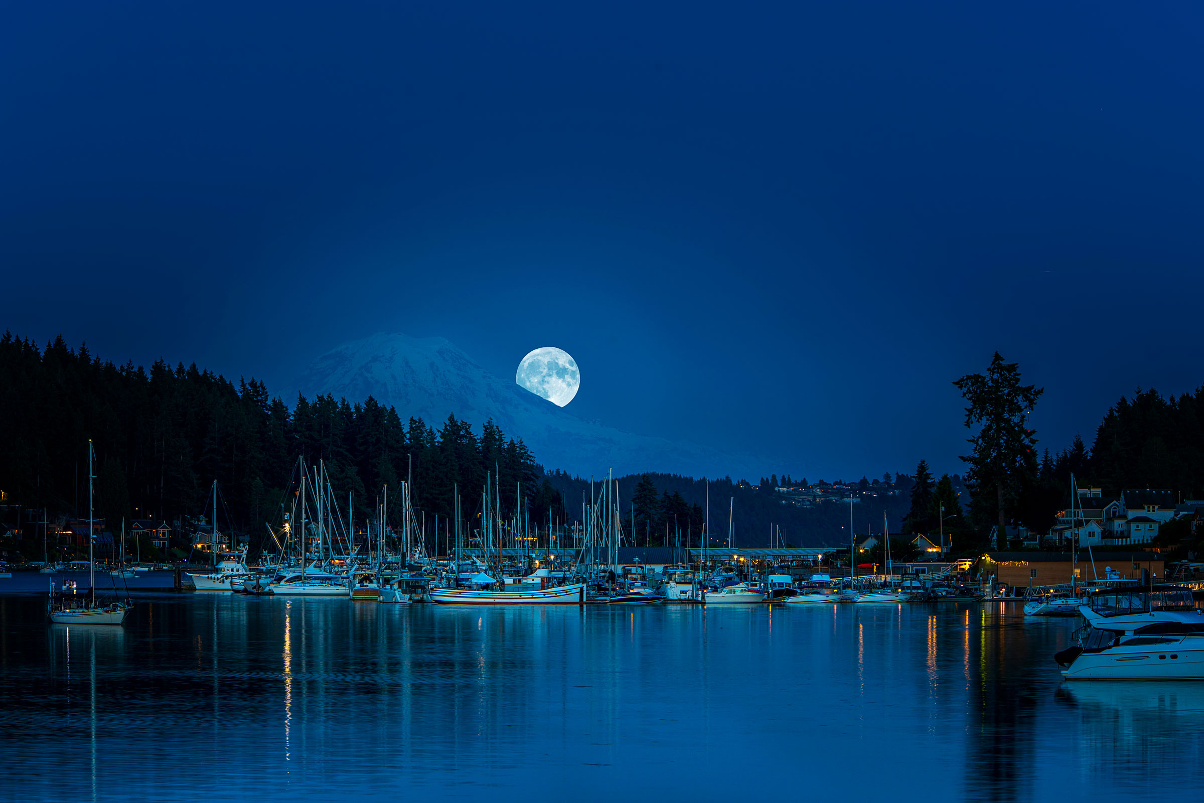 A full moon lights up the boats in Gig Harbor, washington.